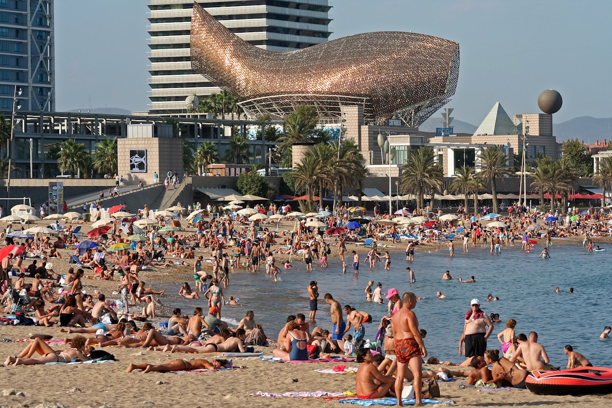 Barceloneta Beach with Frank Gehry's Peix d'Or (Whale Sculpture) on the beach of Barceloneta in Barcelona, Spain.