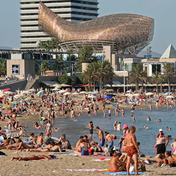 Barceloneta Beach with Frank Gehry's Peix d'Or (Whale Sculpture) on the beach of Barceloneta in Barcelona, Spain.