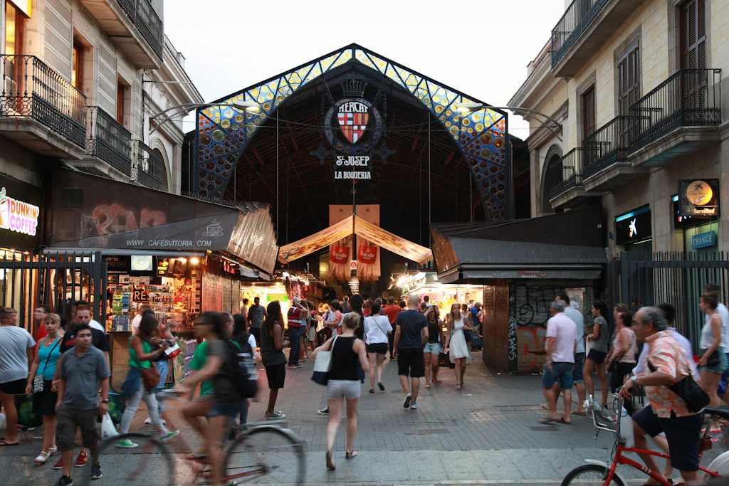 Mercat de la Boqueria, Barcelona People walking near the entrance to La Boqueria, a marketplace located off La Rambla.