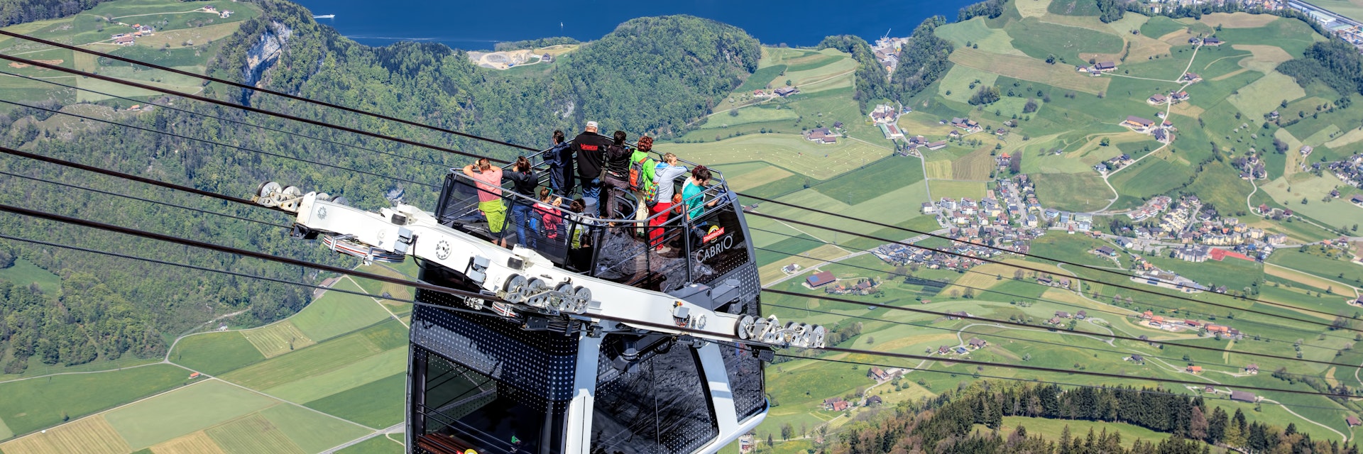 People in a gondola of the Stanserhorn Cabrio cable car. 