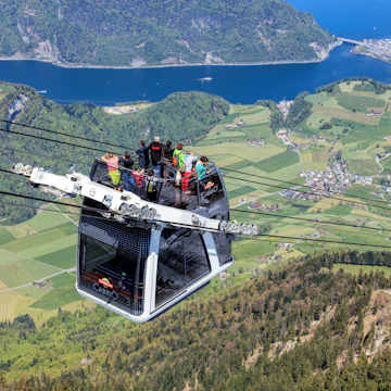 People in a gondola of the Stanserhorn Cabrio cable car.
