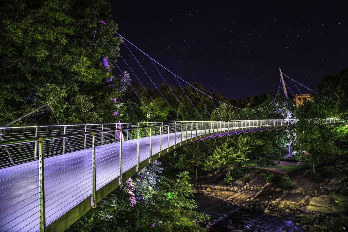 Illuminated Liberty Bridge in Falls Park downtown Greenville South Carolina on a starry night.