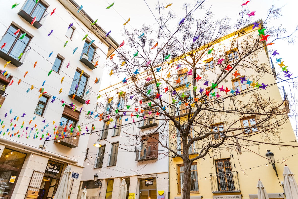 Decoration in the colorful square of the market of the Tapineria, center of the city of Valencia, where the tourists stop to rest and taste the typical Mediterranean meals, seen from below.