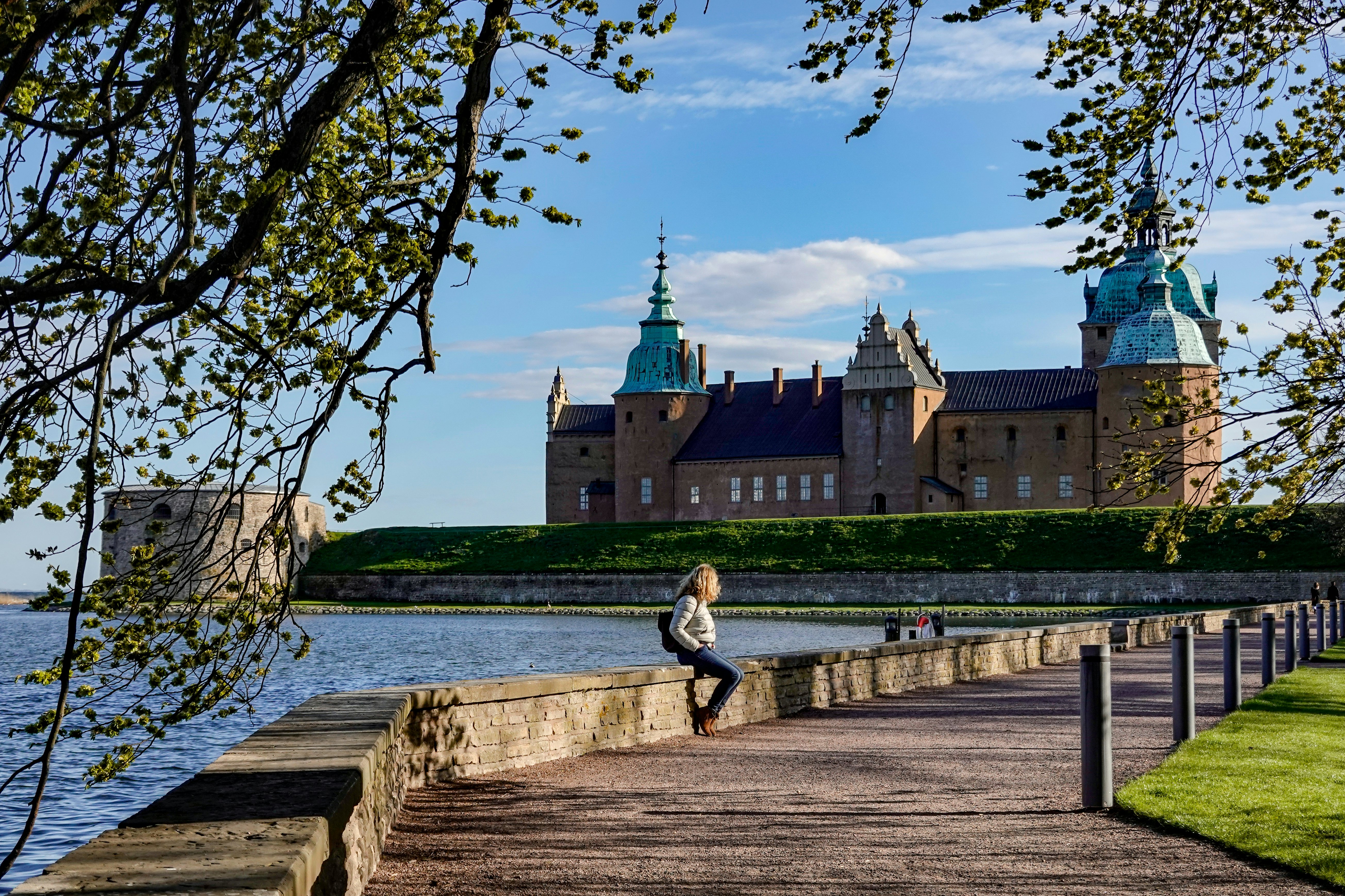 Kalmar, Sweden May 10, 2020 A woman sits on a wall on the grounds of the Kalmar Castle.; Shutterstock ID 1728247585; your: Sloane Tucker; gl: 65050; netsuite: Online Editorial; full: POI
1728247585