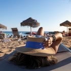 Beautiful Vietnamese asian woman relaxing on the beach bed facing the Atlantic Ocean in Lisbon, Portugal. Rear view of a stylish girl wearing a summer white dress. Girl on vacation concept of freedom.; Shutterstock ID 1811871973; purchase_order: 65050 / Online Editorial/ Best Lisbon beaches; job: ; client: Tasmin Waby; other:
1811871973
