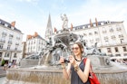 Young and happy woman tourist with photo camera standing near the fountain on the Royal square in Nantes city, France; Shutterstock ID 673491862; purchase_order: 65050 / online editorial / nantes first time; job: ; client: ; other:
673491862