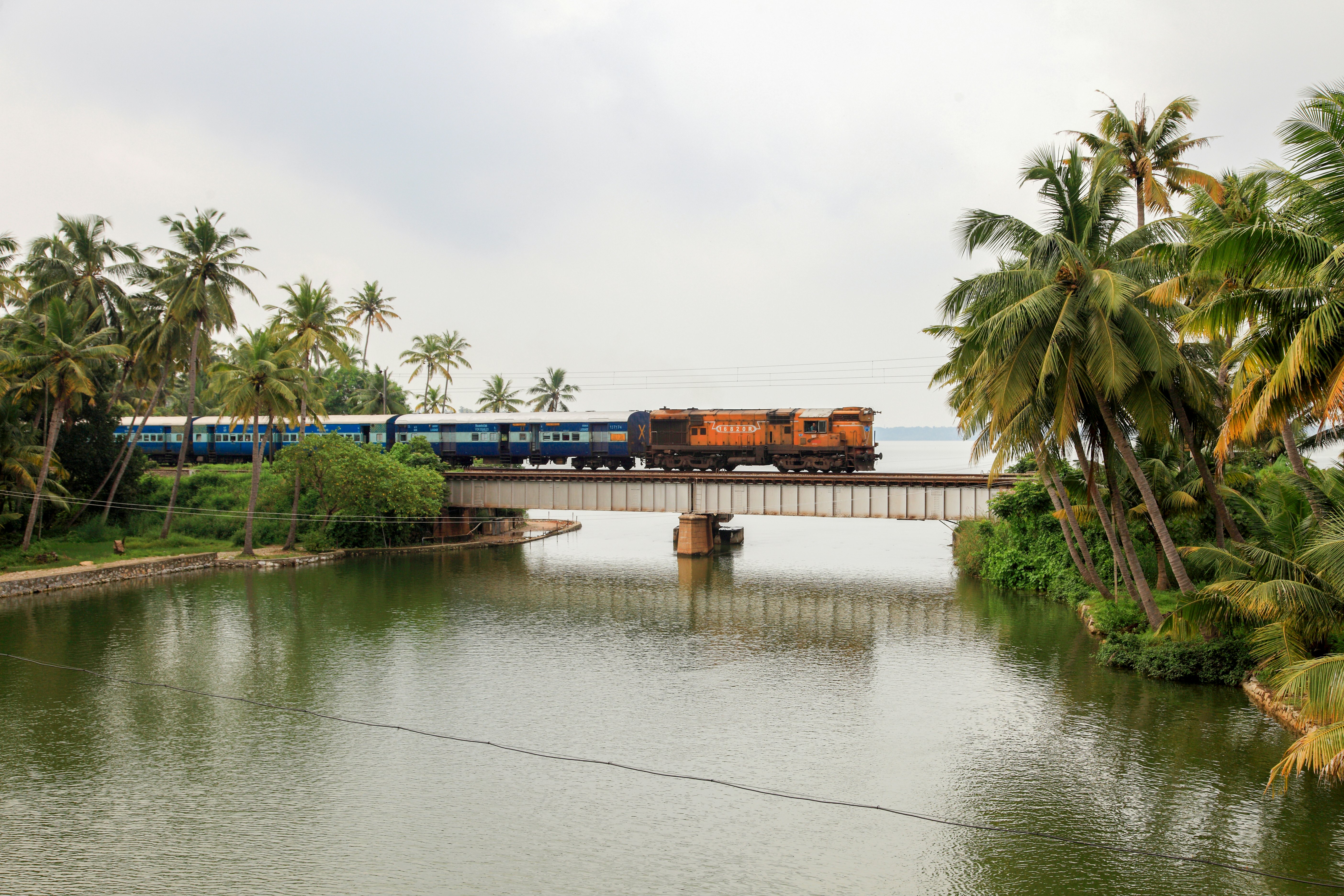 A train passes through a railway bridge in Manroe Island on October 15, 2017 in Kollam,Kerala, India.