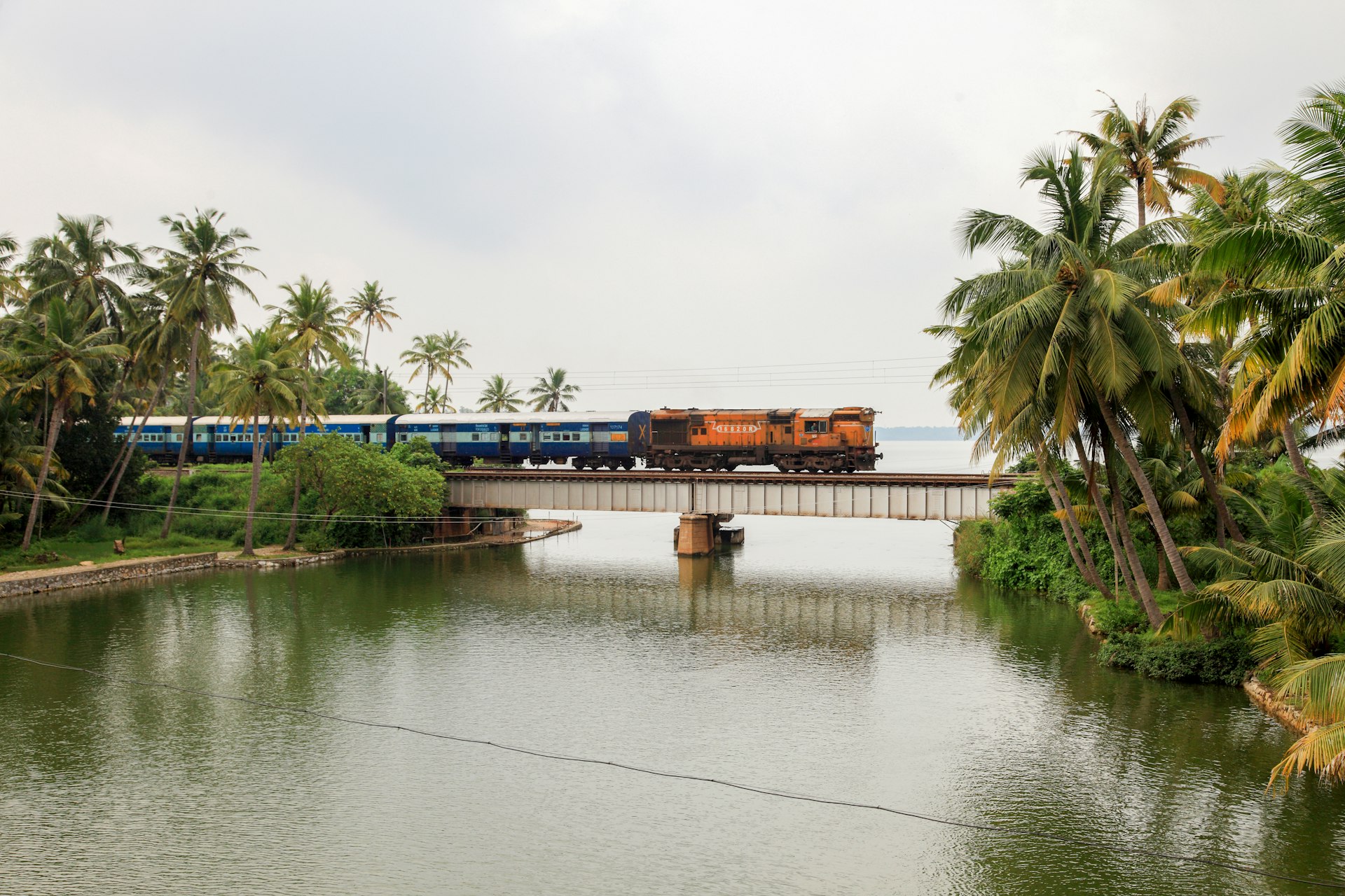 A train passes through a railway bridge in Manroe Island on in Kollam, Kerala, India