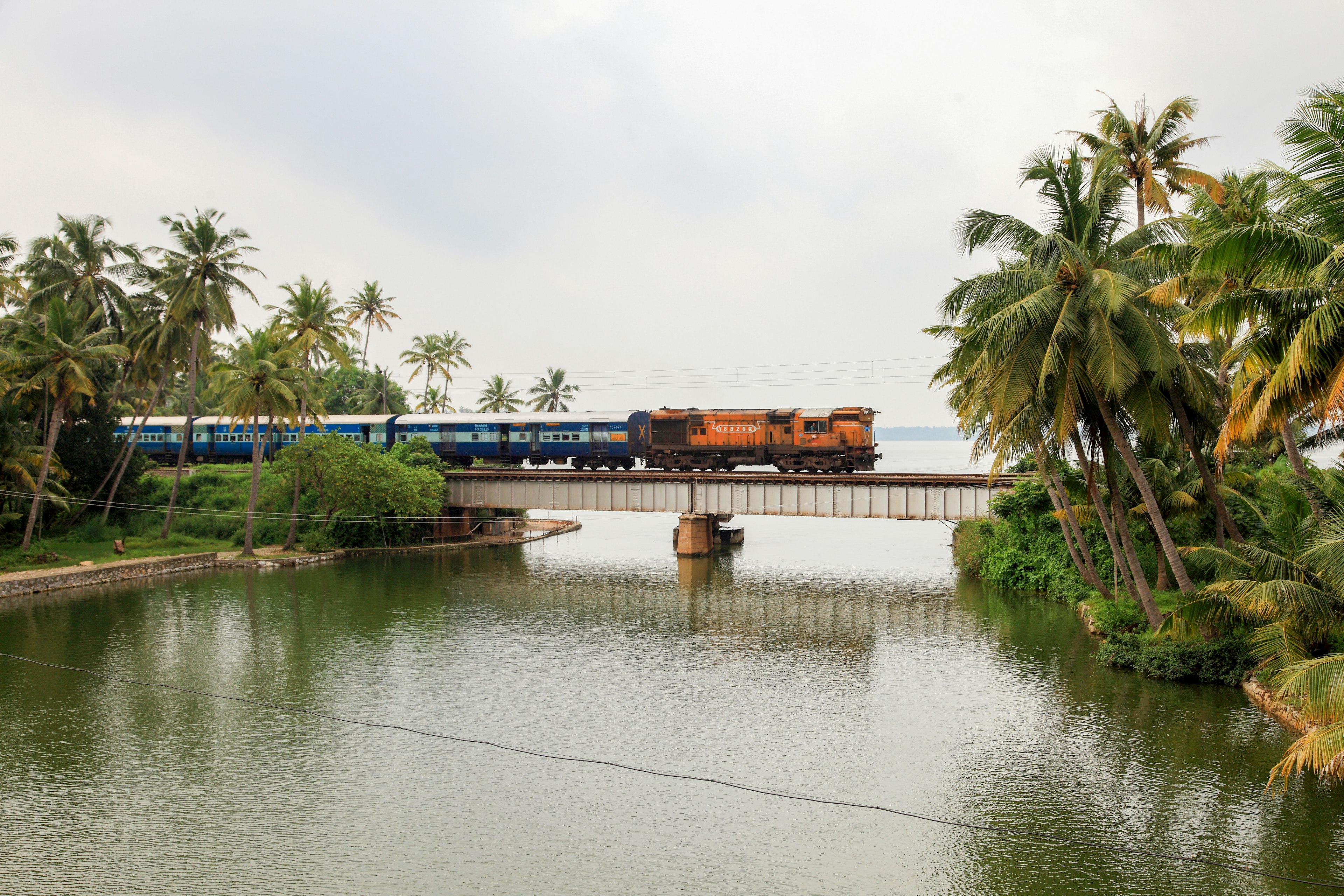 A train passes through a railway bridge in Manroe Island on October 15, 2017 in Kollam,Kerala, India.