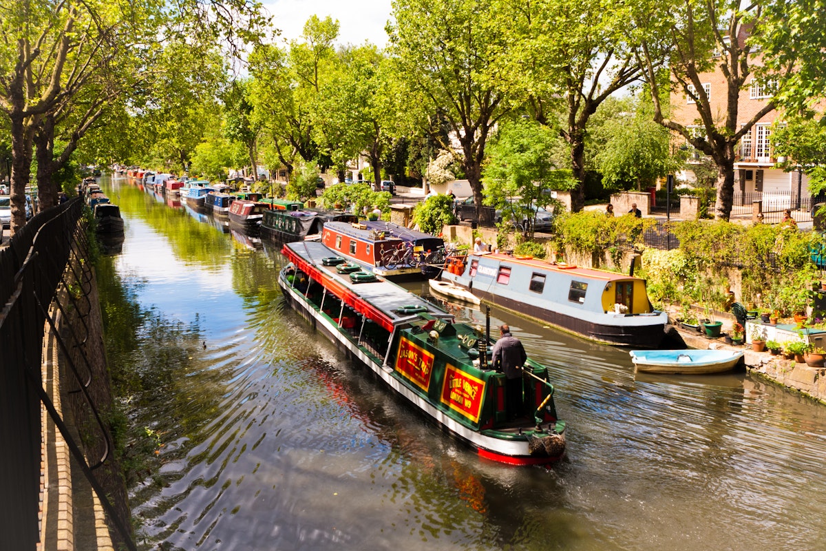 A boat sailing on Regent's Canal in Little Venice, London, England.