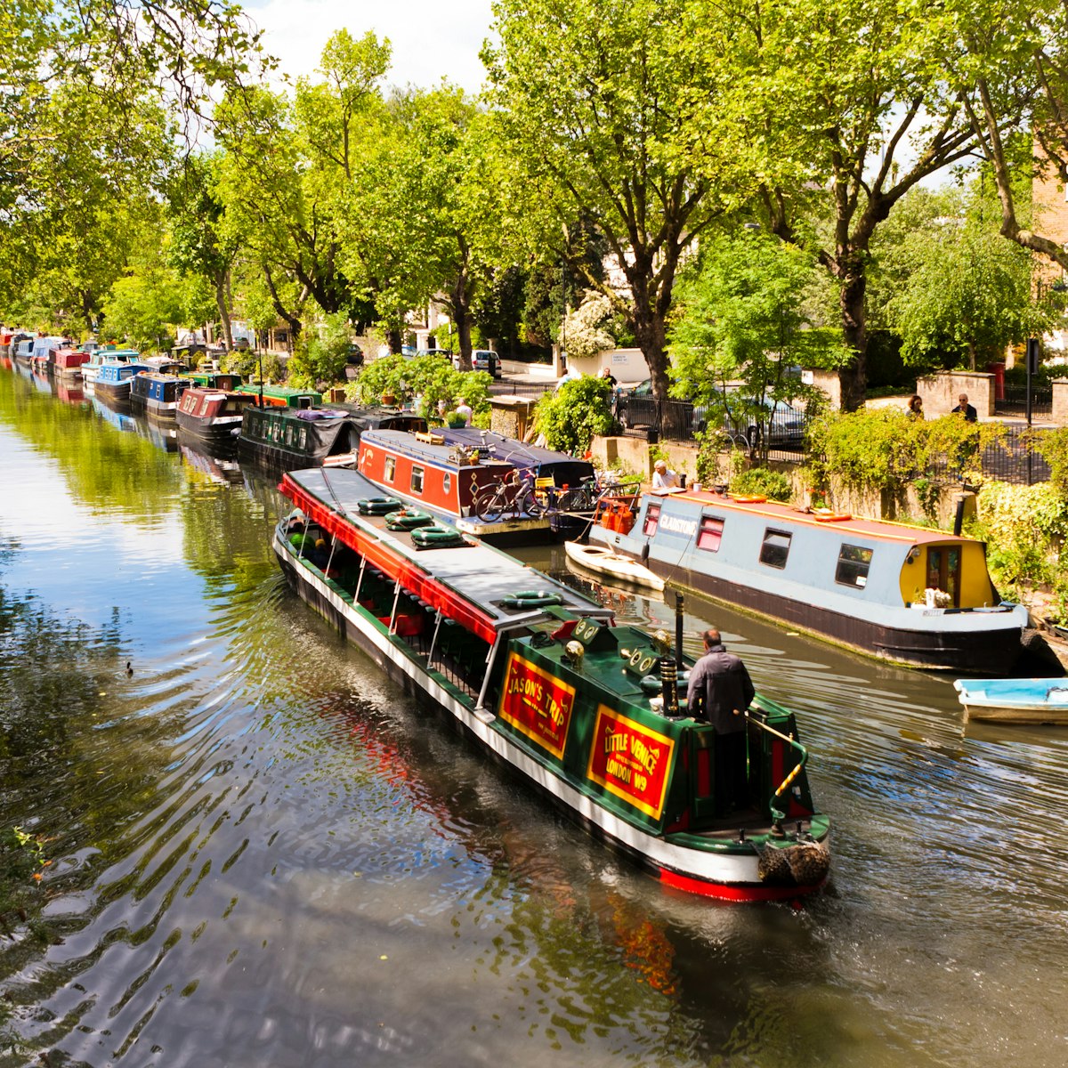 A boat sailing on Regent's Canal in Little Venice, London, England.