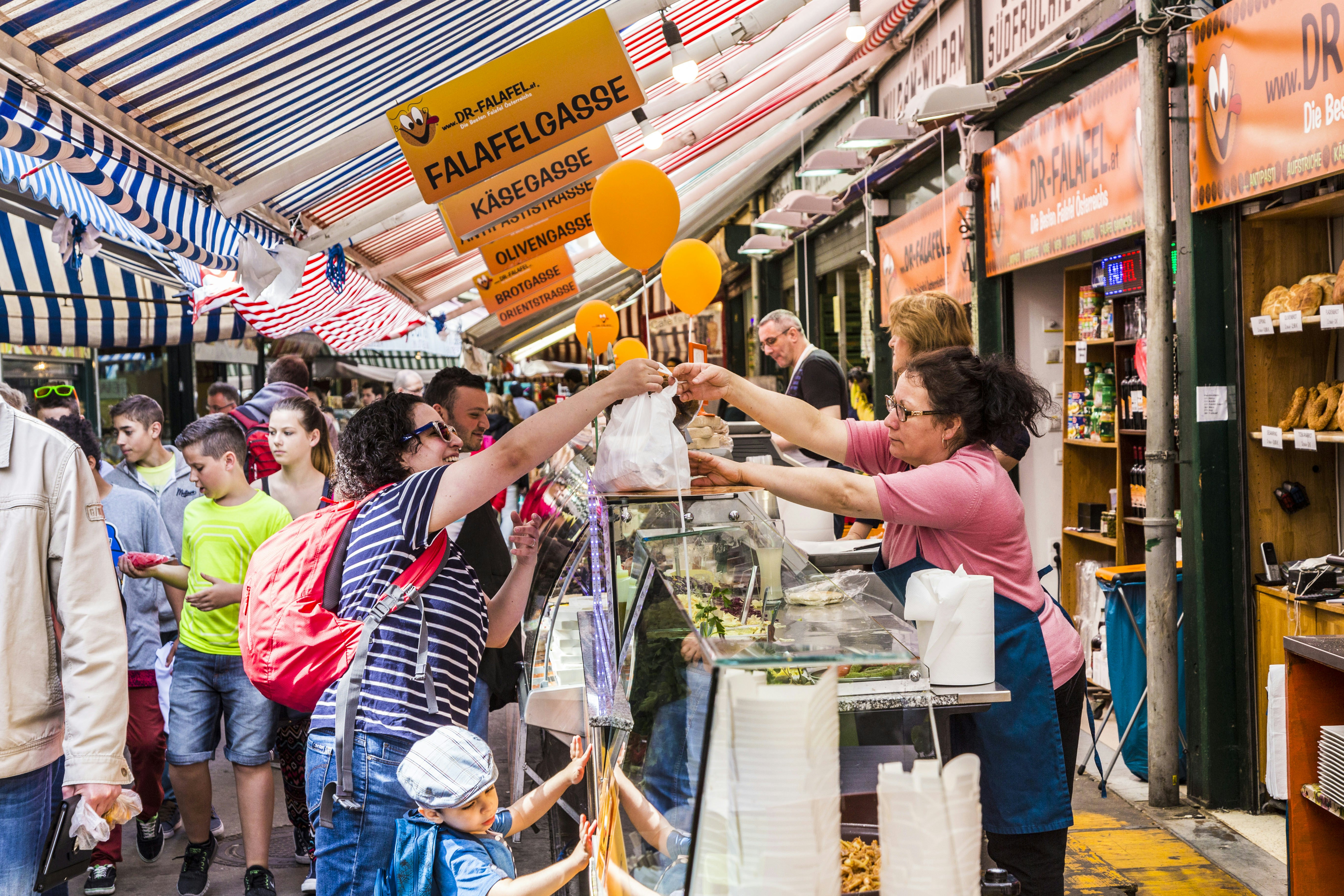 People enjoy the Naschmarket in Vienna.