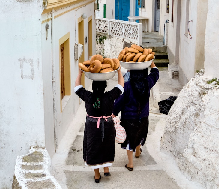 Women carry bowls of bread for Easter celebrations down a narrow lane in Olympos on Karpathos Island.
680890168
activity, architecture, basins, beautiful, black dress woman, blue, breads, building, clothes, culture, dress, easter, ethnic, europe, greece, holiday, house, island, karpathos, old, olympos, outdoor, paths, people, person, pies, religion, rocks, savoury, scarf, scenery, street, summer, tourism, traditional, traditional clothes, travel, village, white, women