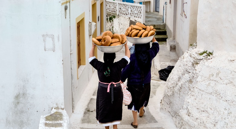 Women carry bowls of bread for Easter celebrations down a narrow lane in Olympos on Karpathos Island.
680890168
activity, architecture, basins, beautiful, black dress woman, blue, breads, building, clothes, culture, dress, easter, ethnic, europe, greece, holiday, house, island, karpathos, old, olympos, outdoor, paths, people, person, pies, religion, rocks, savoury, scarf, scenery, street, summer, tourism, traditional, traditional clothes, travel, village, white, women