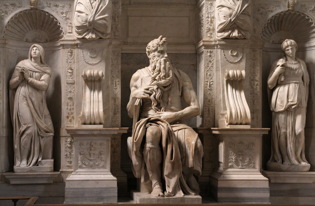 Statue of Moses by Michelangelo in Basilica di San Pietro in Vincoli A huge statue of a male figure flanked by two female figures