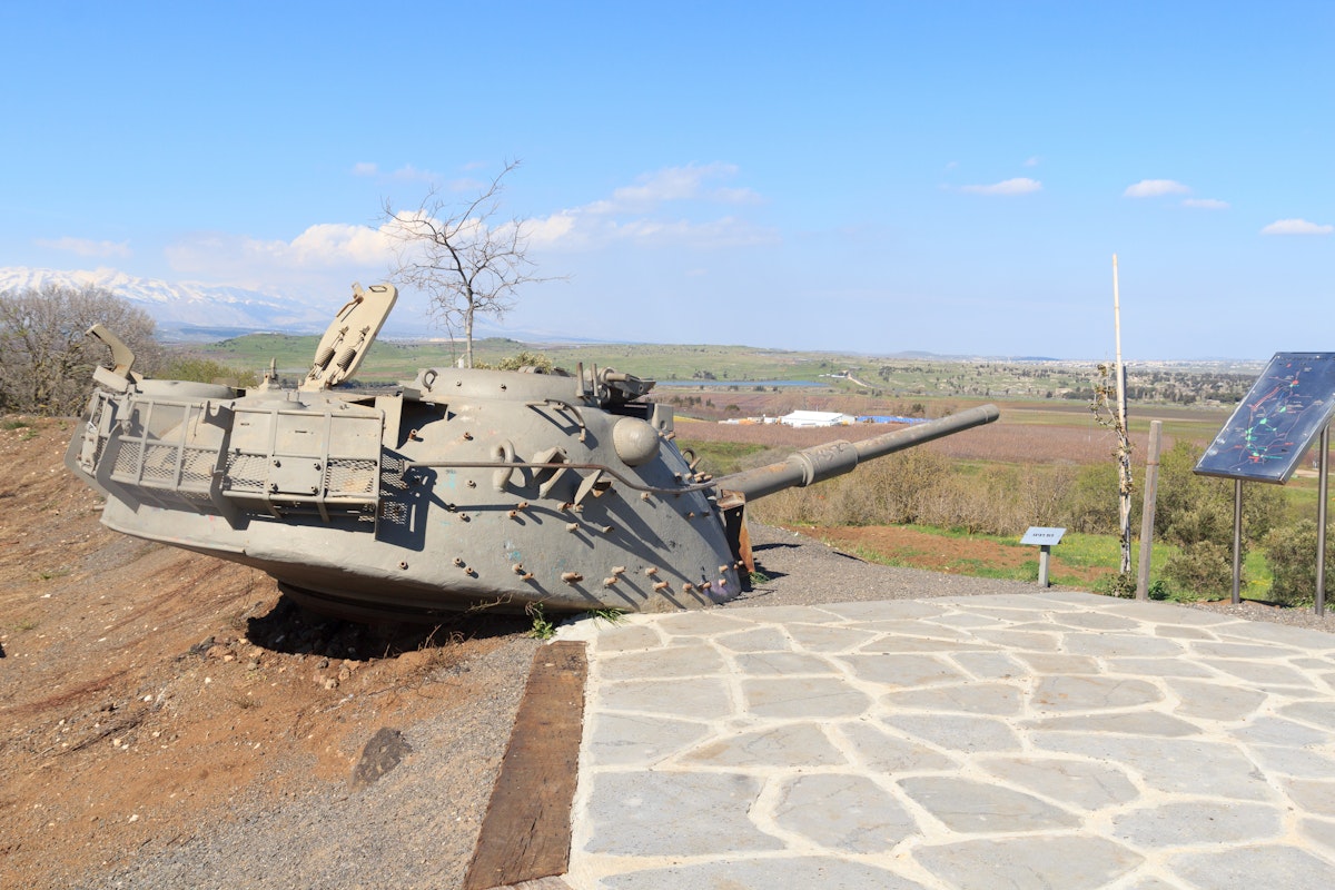 Yom Kippur War memorial at Quineitra viewpoint on Golan Heights with Israeli tank turret aiming towards Syria. The site overlooks the ruined town of Quneitra.