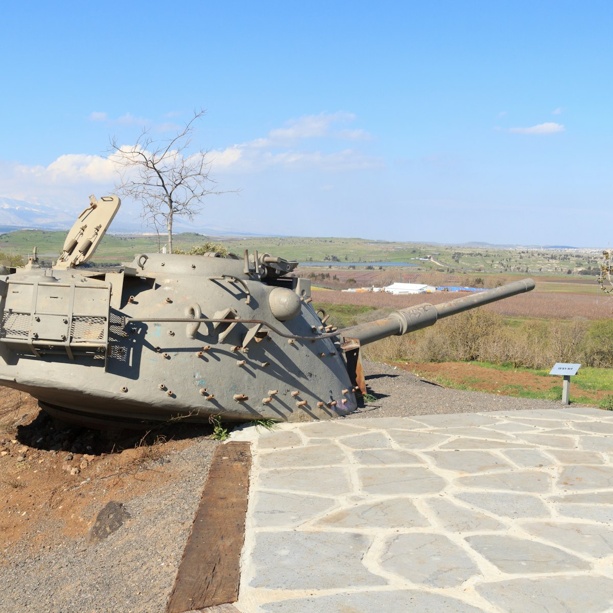 Yom Kippur War memorial at Quineitra viewpoint on Golan Heights with Israeli tank turret aiming towards Syria. The site overlooks the ruined town of Quneitra.