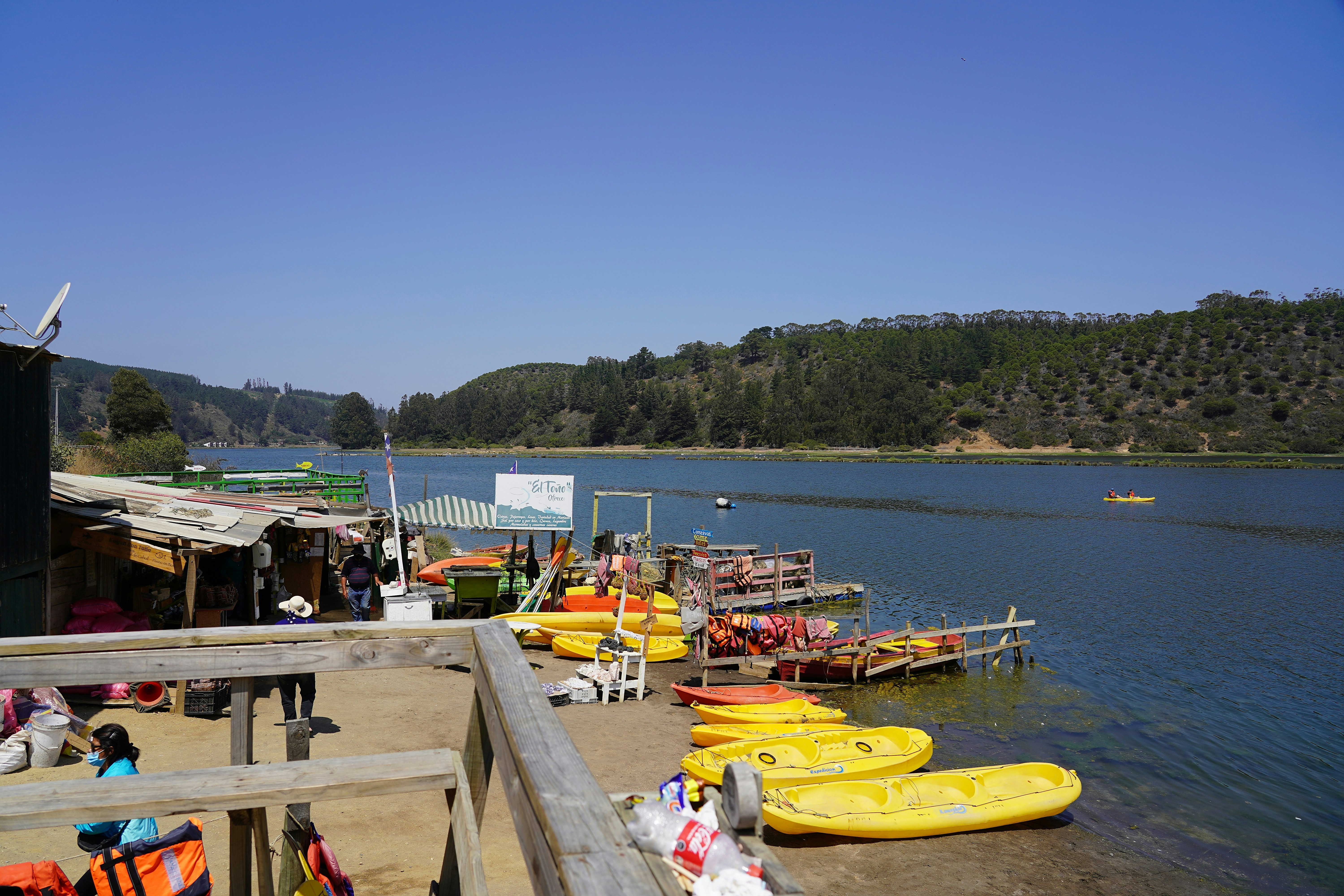View of the laguna and tourist boats on summer day in Cahuil, Pichilemu, Chile.
