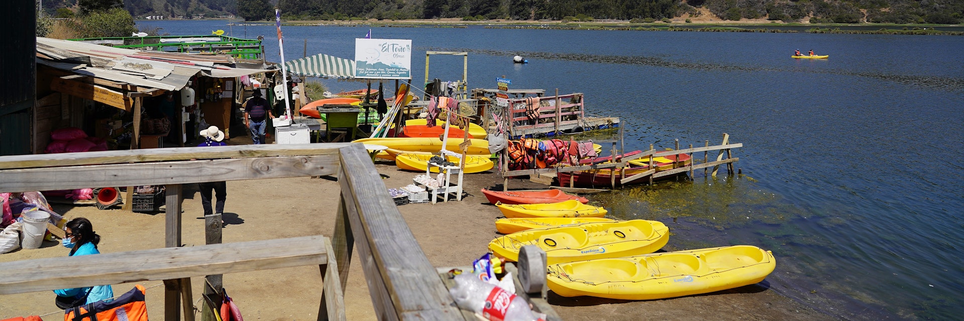 View of the laguna and tourist boats on summer day in Cahuil, Pichilemu, Chile.