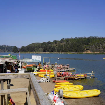 View of the laguna and tourist boats on summer day in Cahuil, Pichilemu, Chile.
