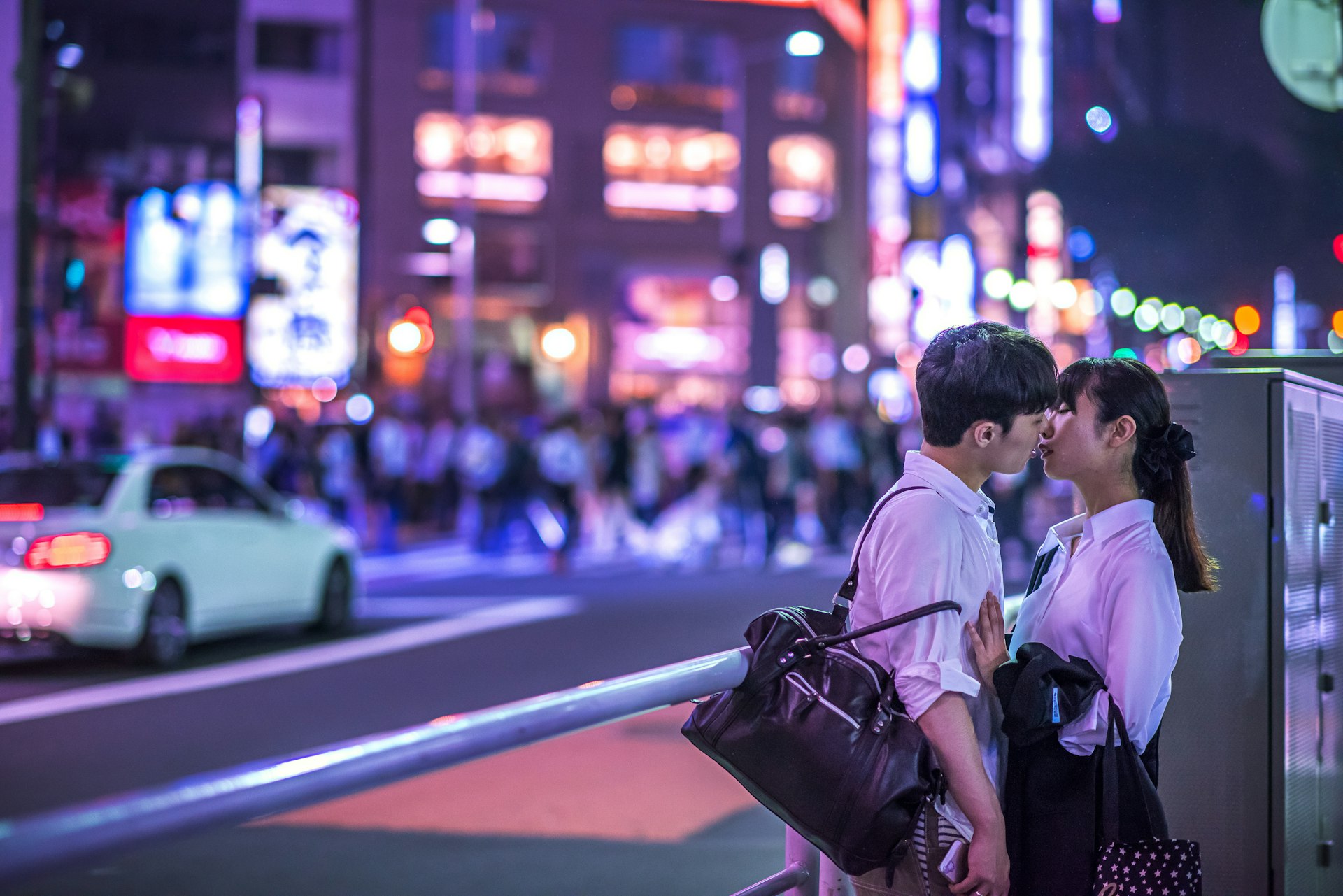 Young couple kissing on a street in Shibuya, Tokyo