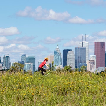 Cycling in front of the skyline from Tommy Thompson Park in Toronto Ontario Canada.