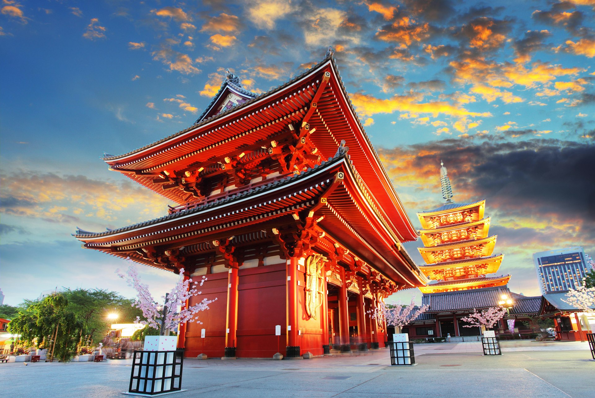 An exterior  image of the Buddhist temple of Senso-ji lit up at dusk
