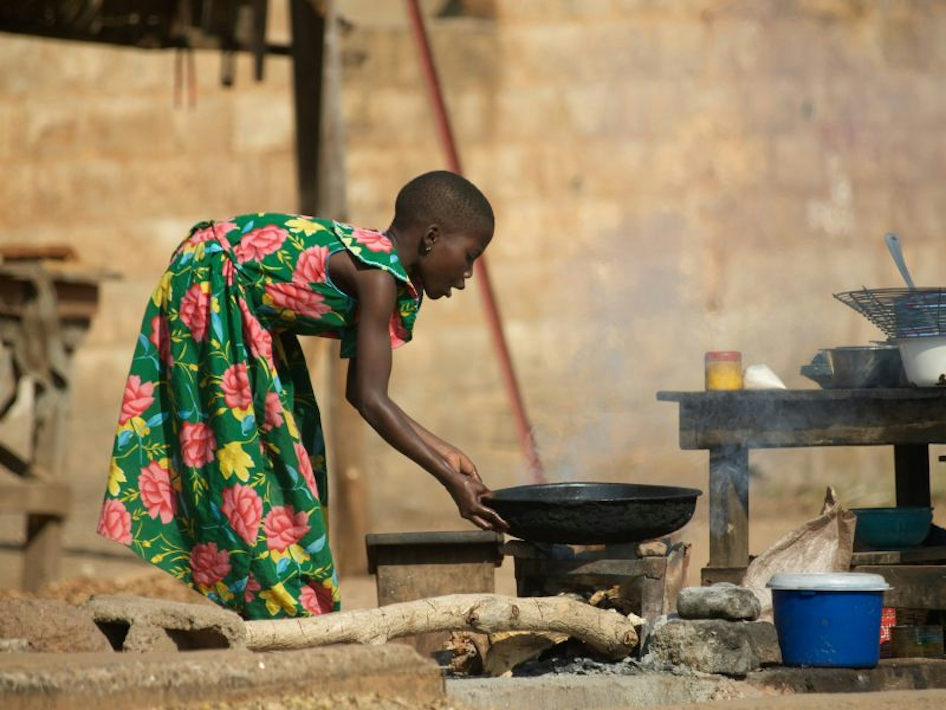 Woman cooking on a street kitchen in Benin