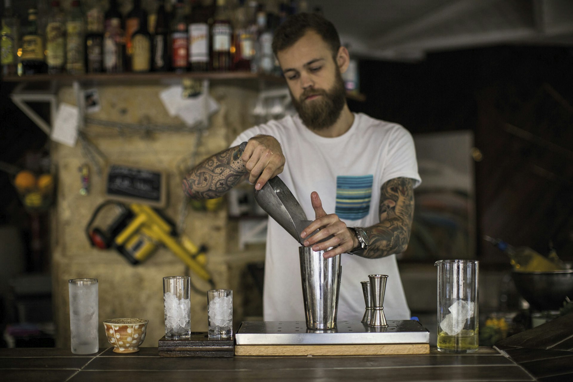 Barman making cockatils at Le Mary Celeste bar, Le Marais.