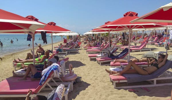 What is the towel movement taking over Greece's beaches?