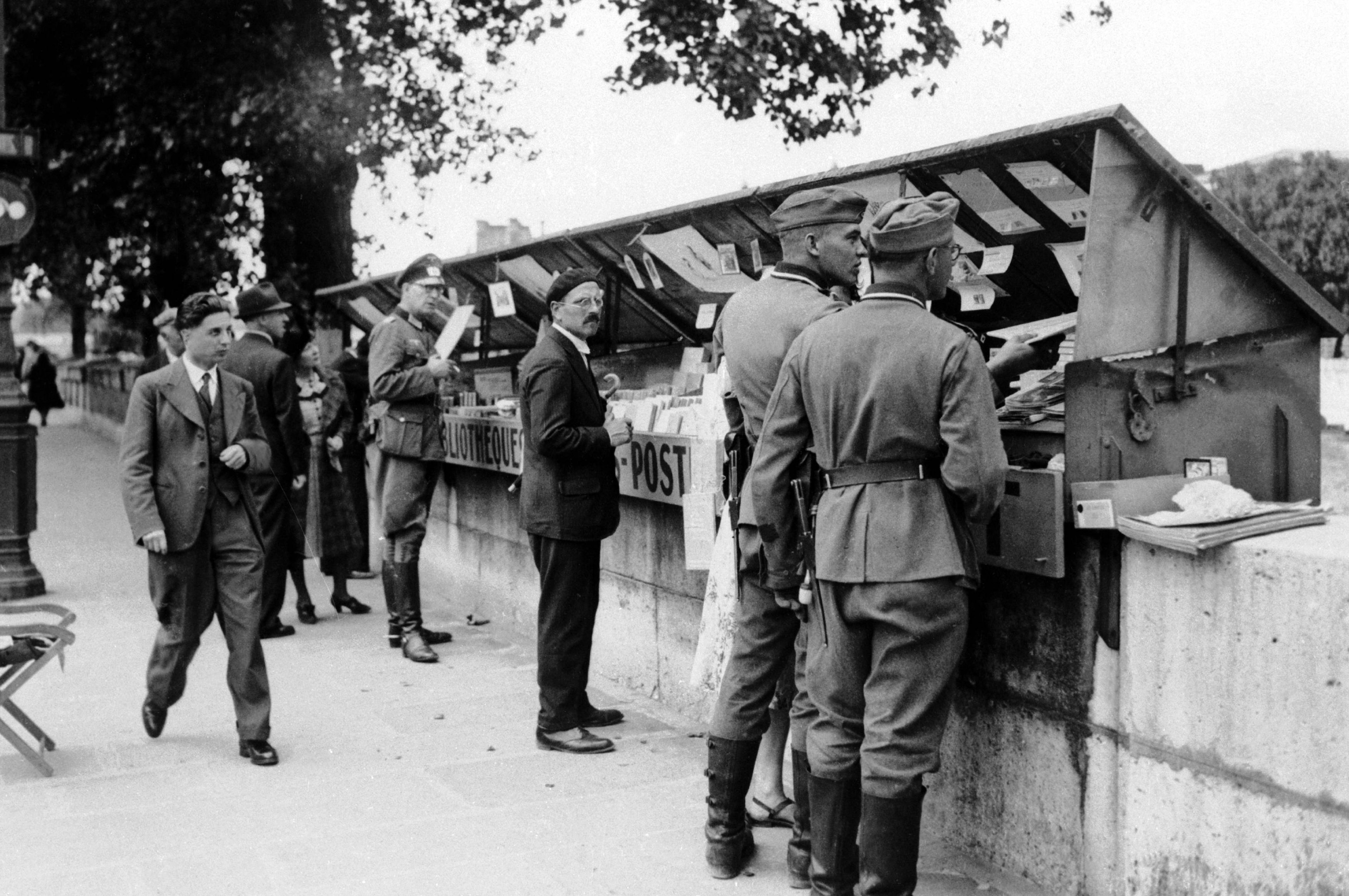 German soldiers browse the bookstalls of the Seine in 1940