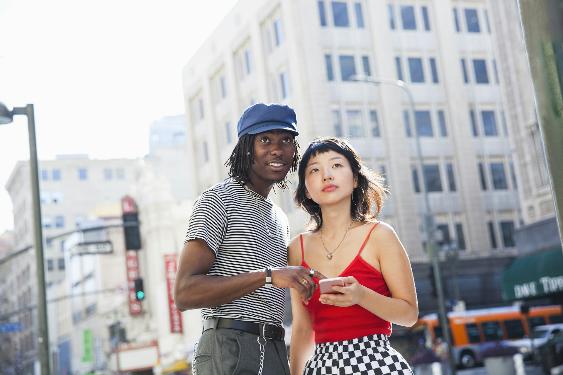 A man and woman using a smartphone to get around in Los Angeles, California