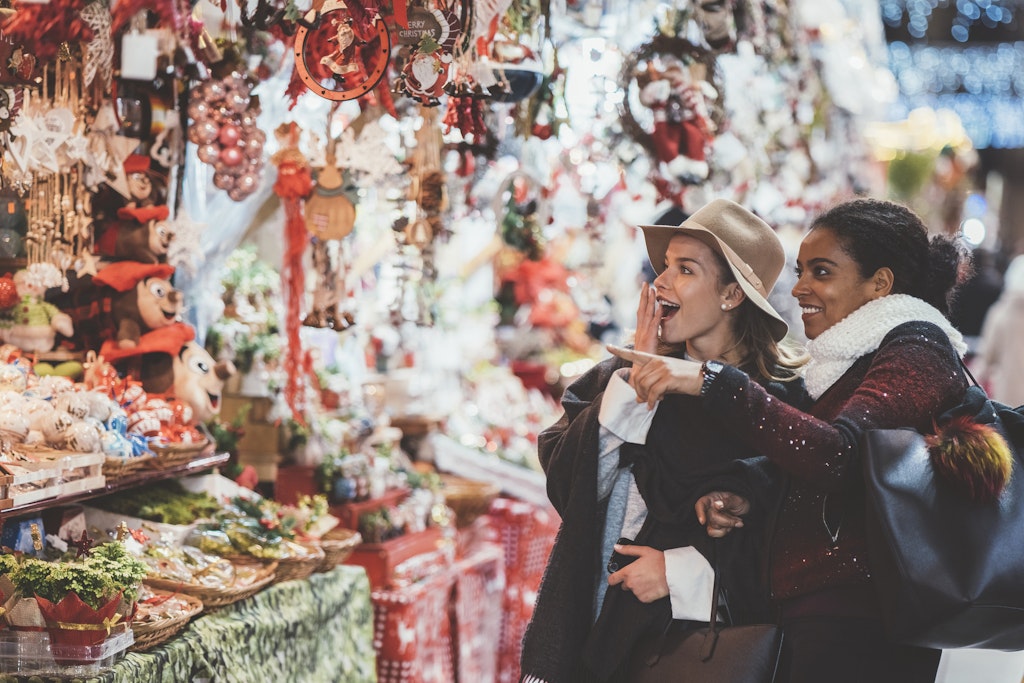 Two women shopping together at a Barcelona Christmas market