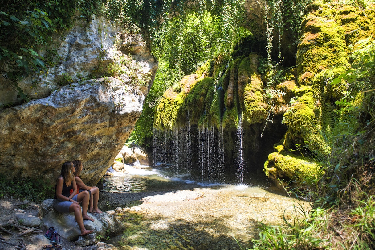 Two women looking at a little waterfall in Capelli di venere, Casaletto Spartano, Campania