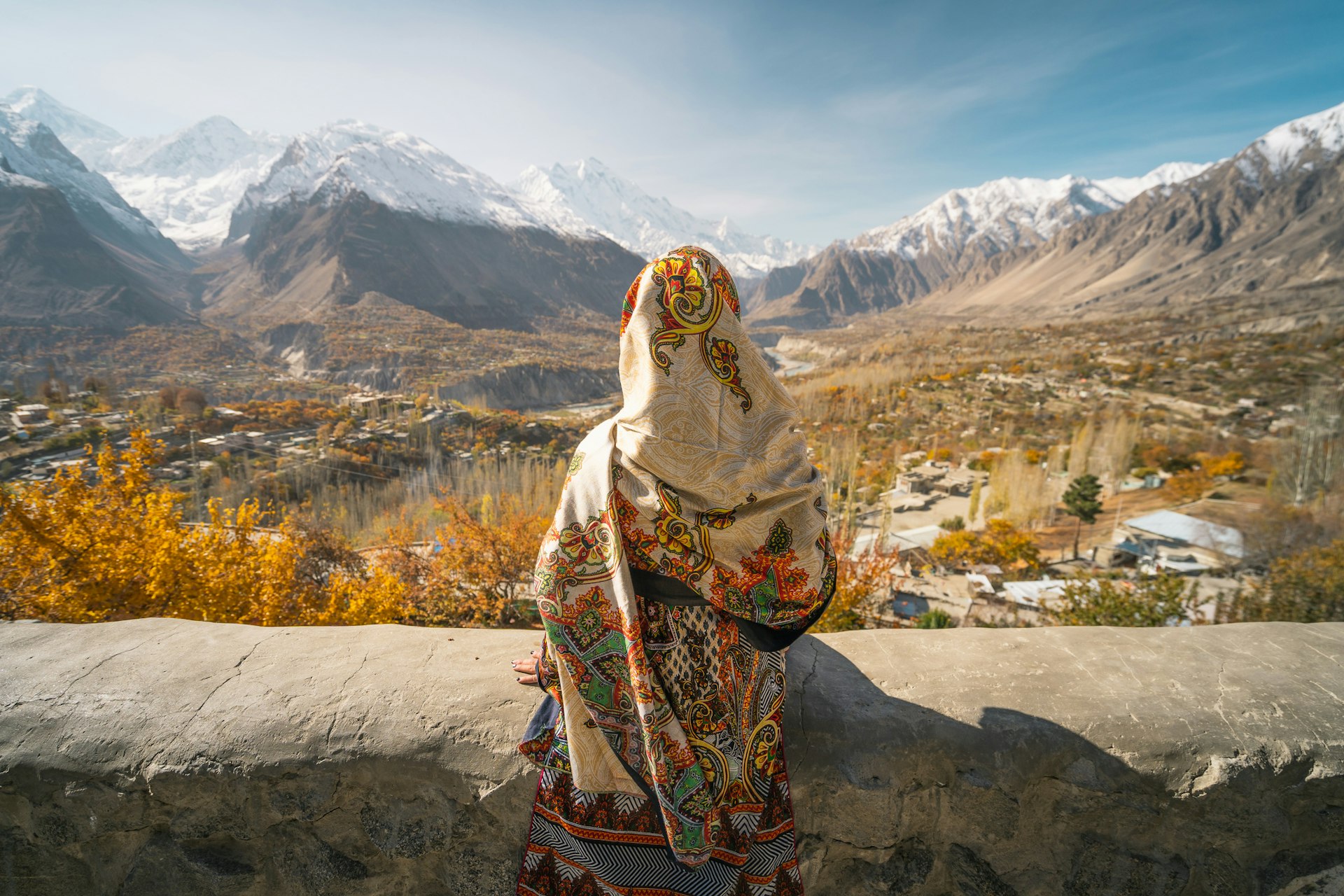 A woman looks over the Hunza Valley, Pakistan