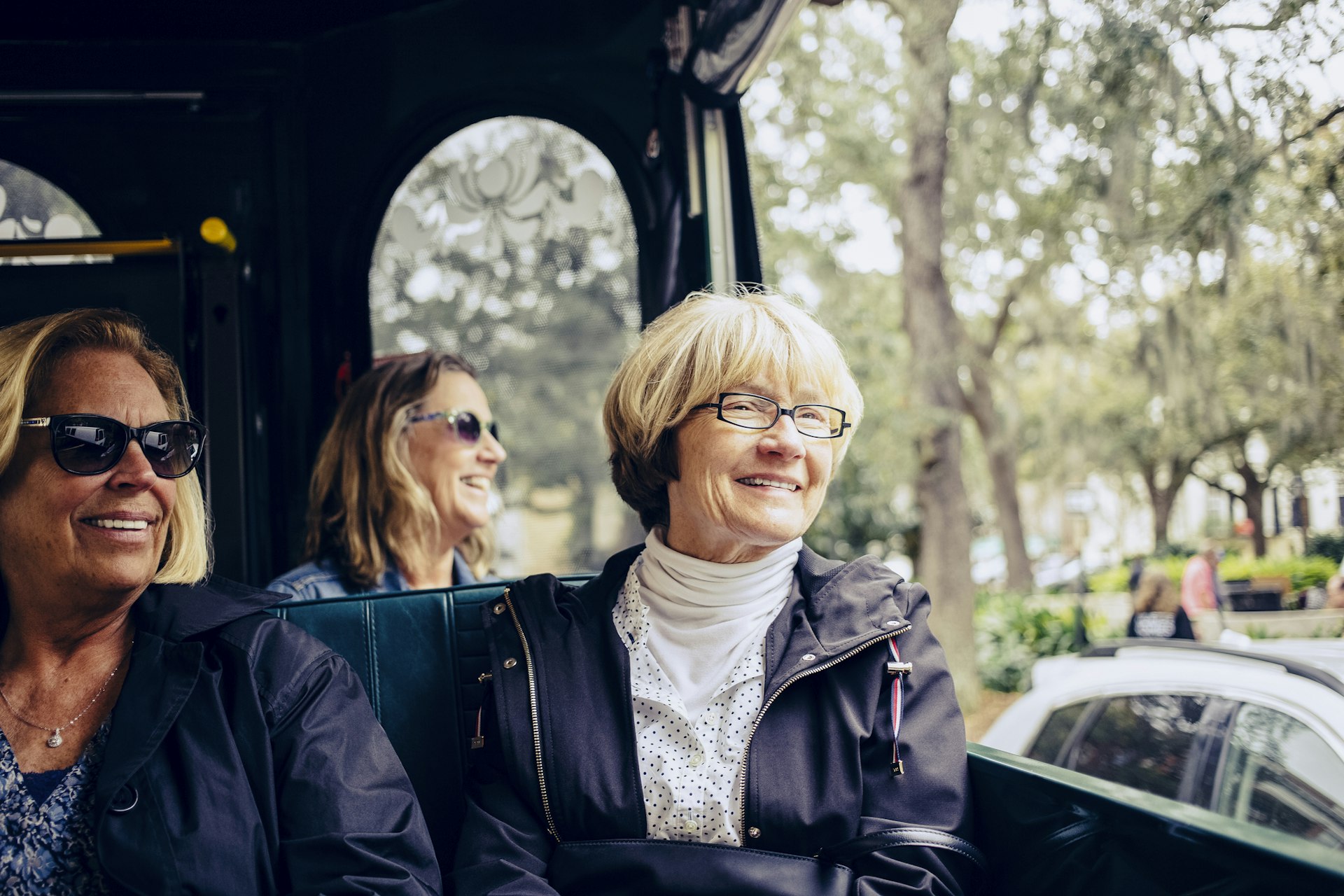 Three women sightseeing on a trolley bus in Savannah, Georgia