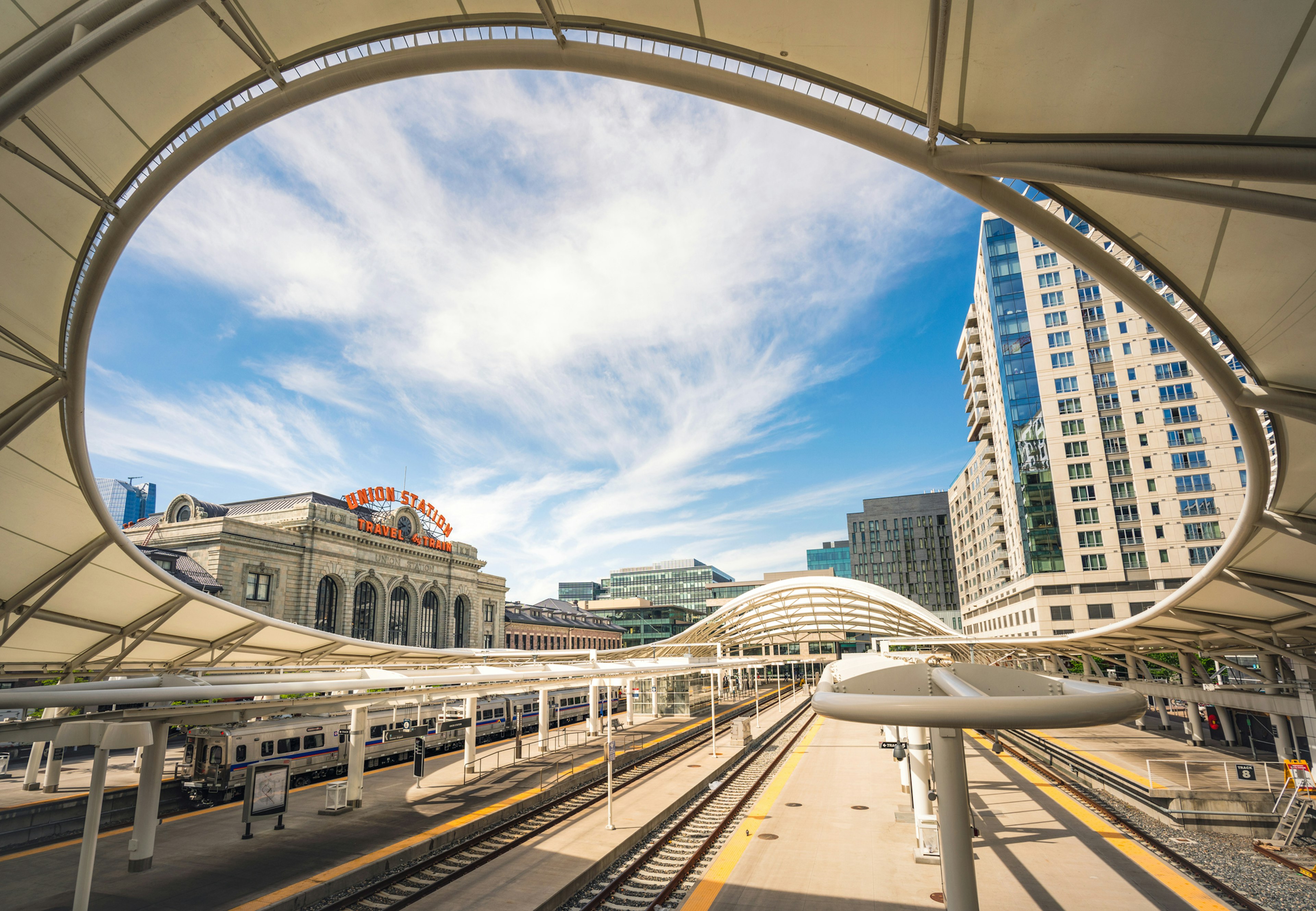 Train station platforms with a large arching roof