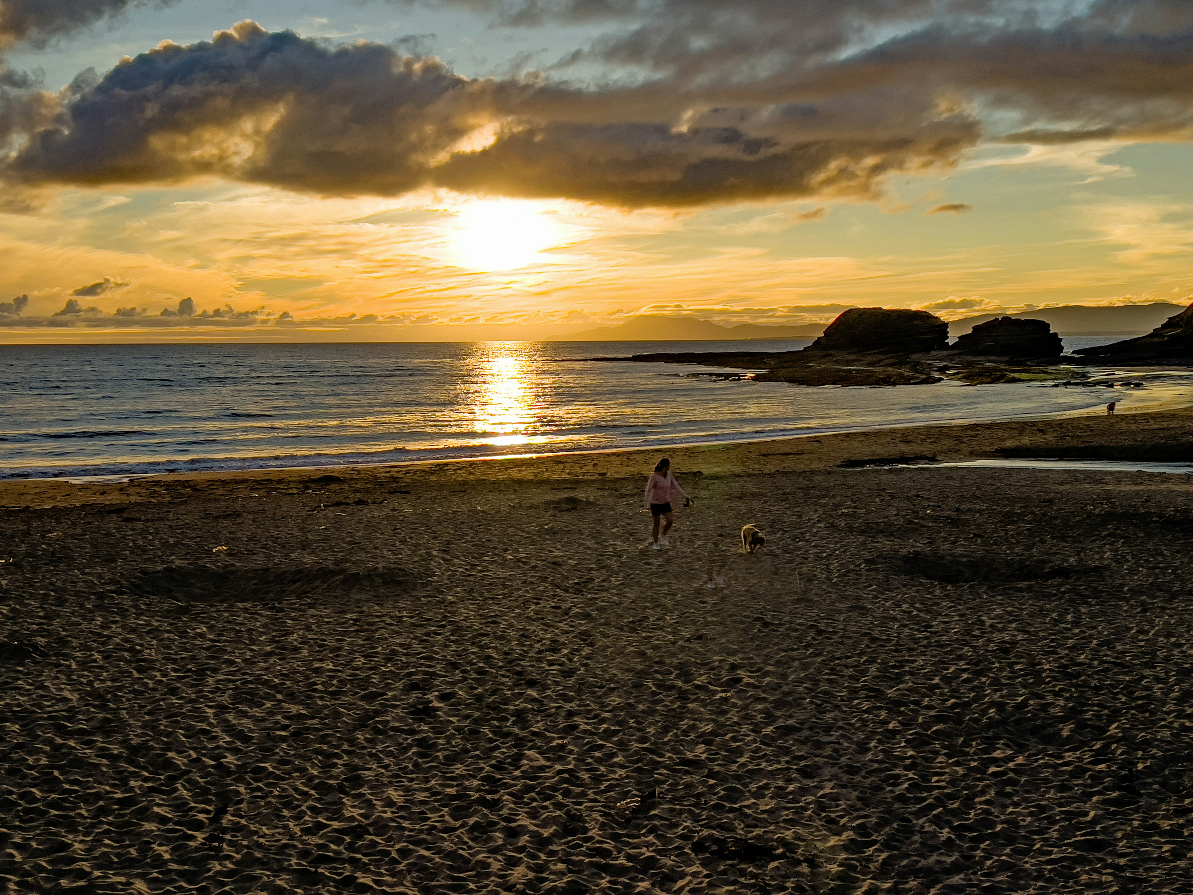 Kids play on the beach at sunset in Bundoran, Ireland