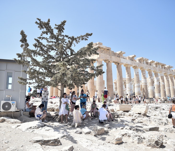 ATHENS, GREECE - JULY 20: Atop the Acropolis ancient hill with Parthenon temple in background, tourists hide from burning sun during a heat wave on July 20, 2023 in Athens, Greece. The Acropolis of Athens and other archaeological sites in Greece announced reduced opening hours due to the heatwave conditions. Parts of Europe continue to experience extreme conditions of the Cerberus heatwave, dubbed Charon. (Photo by Milos Bicanski/Getty Images) 1558046854