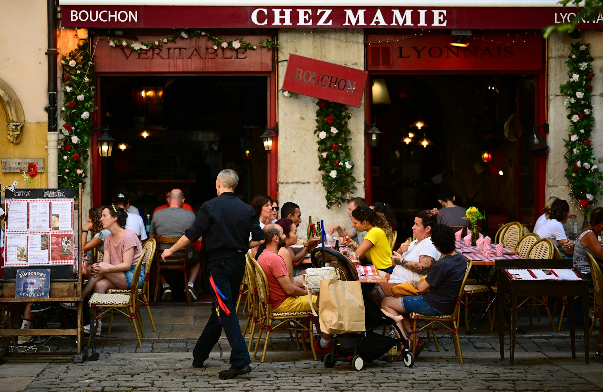 Clients eat at a bouchon, a traditional restaurant, in the old city of Lyon, France