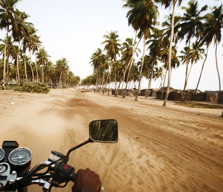 riding a motobike in beach road.
157402646
Middle Of The Road, Road Trip, Travel, People Traveling, Riding, Fishing Village, Coconut Palm Tree, Action, Speed, Motion, Blurred Motion, Human Hand, Benin, West Africa, Africa, Palm Tree, Sand, Country Road, Road, Village, Motorcycle, ouidah
