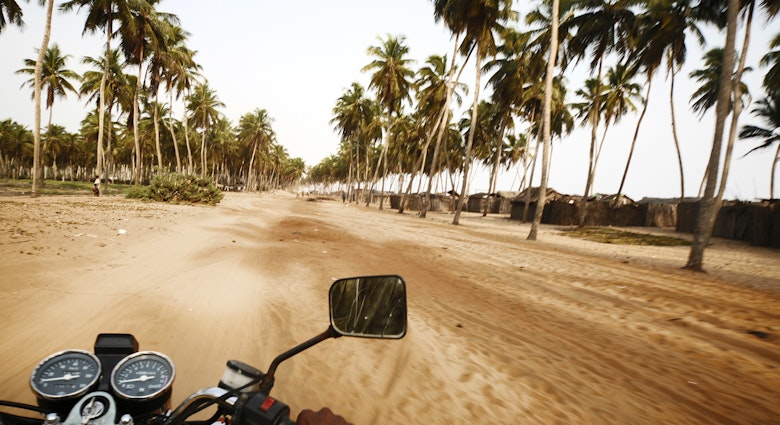 riding a motobike in beach road.
157402646
Middle Of The Road, Road Trip, Travel, People Traveling, Riding, Fishing Village, Coconut Palm Tree, Action, Speed, Motion, Blurred Motion, Human Hand, Benin, West Africa, Africa, Palm Tree, Sand, Country Road, Road, Village, Motorcycle, ouidah