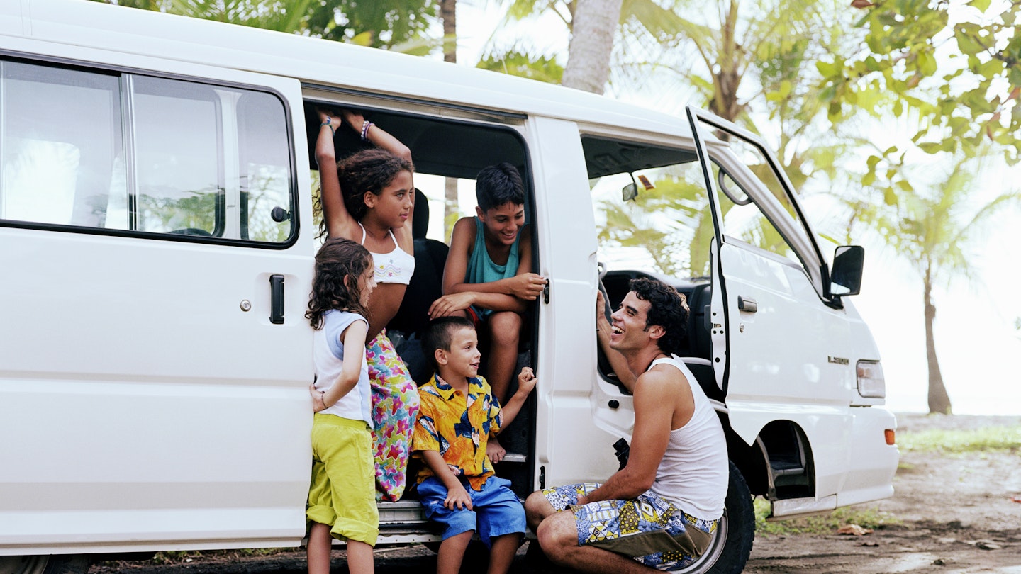 Man with family traveling in van, Playa Bandera, Puntarenas, Costa Rica