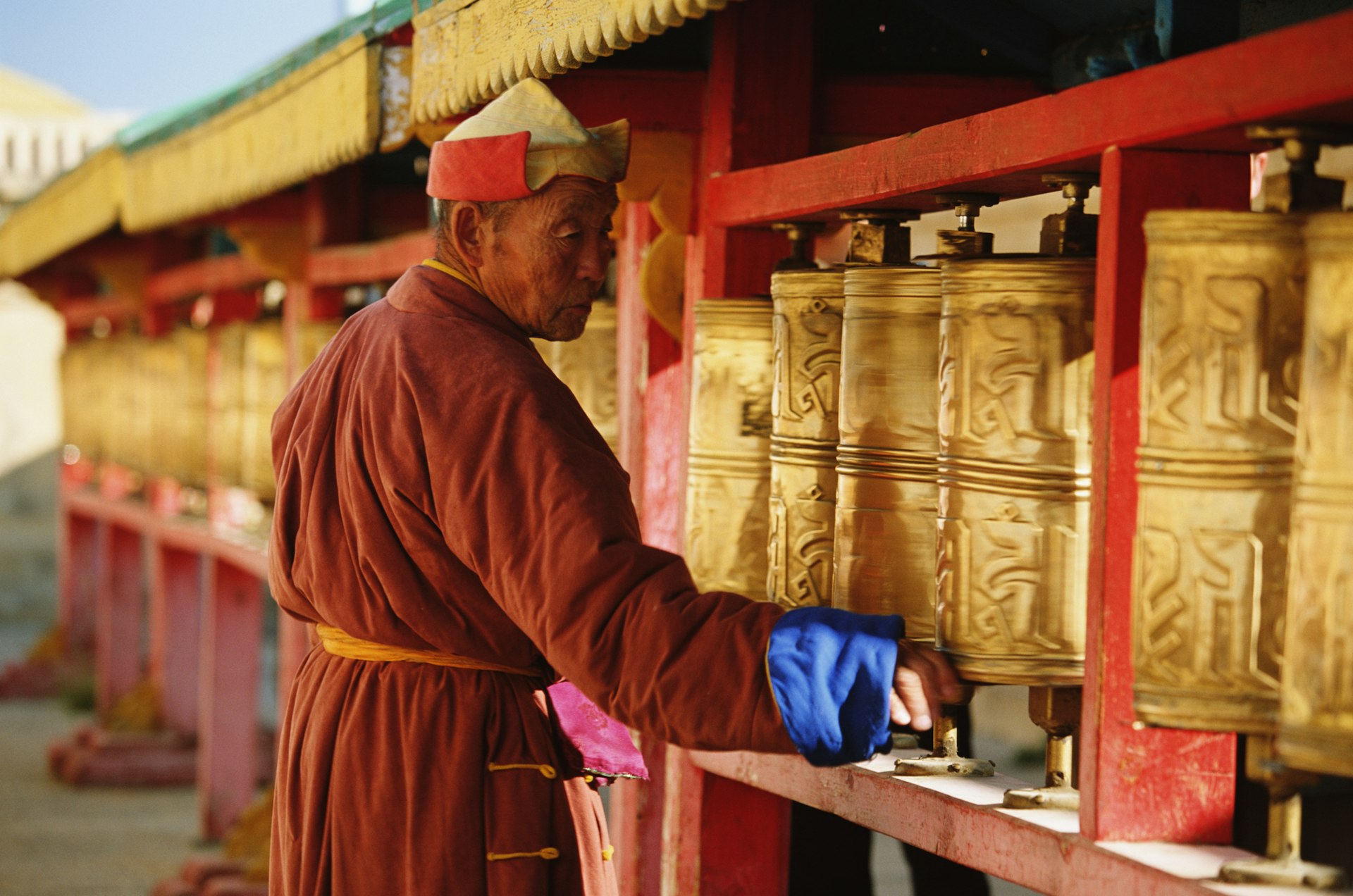 A monk turning prayer wheels in a monastery in Mongolia