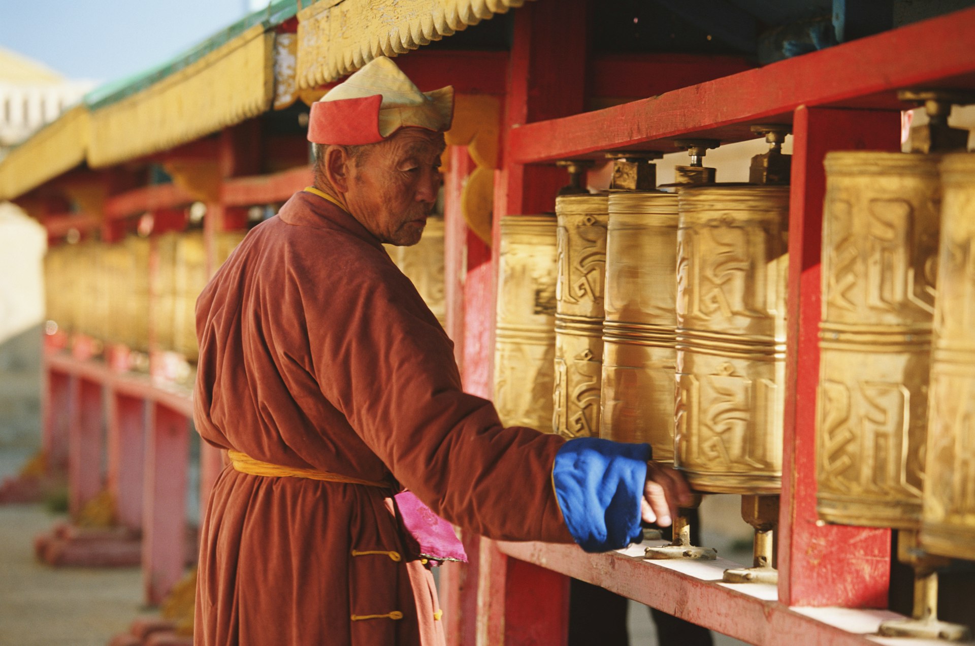 A monk turning prayer wheels in a monastery in Mongolia