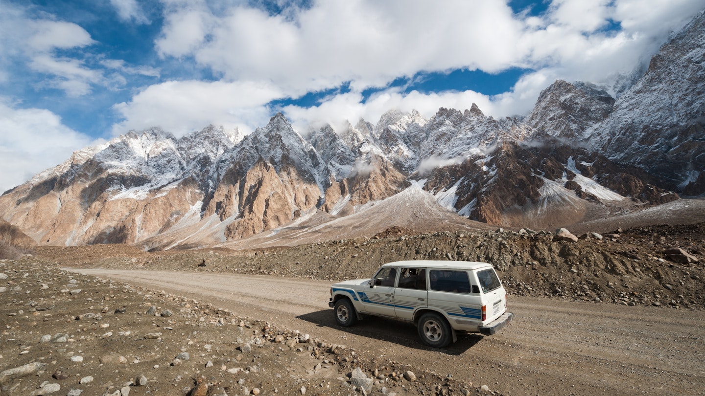 A 4WD on an empty section of the Karakoram Highway, Pakistan