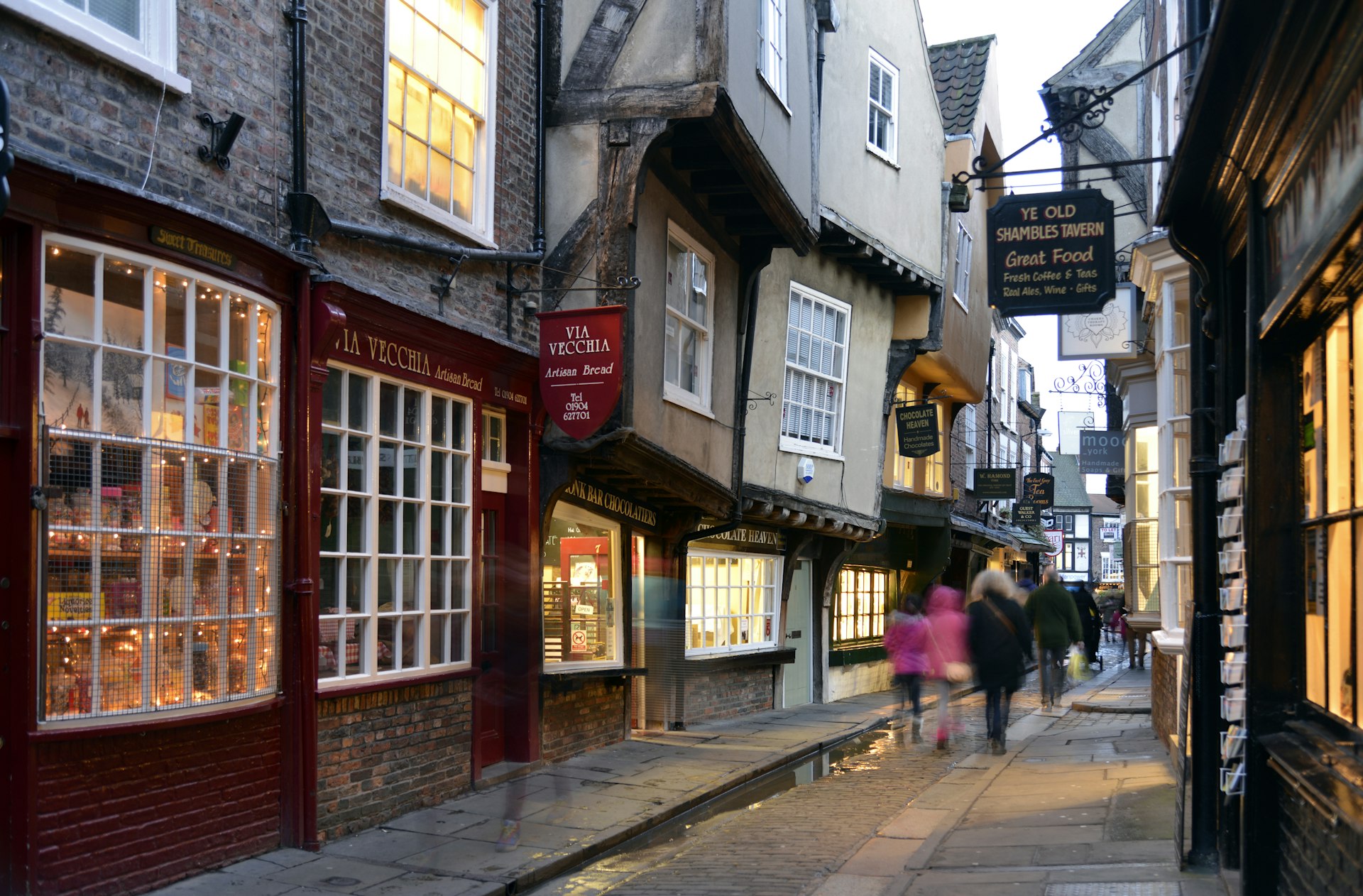People walk in the evening on the Shambles, York, Yorkshire, England, United Kingdom