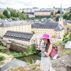 Young female traveler with photocamera enjoying beautiful cityscape view on the old town in Luxembourg city
809811716