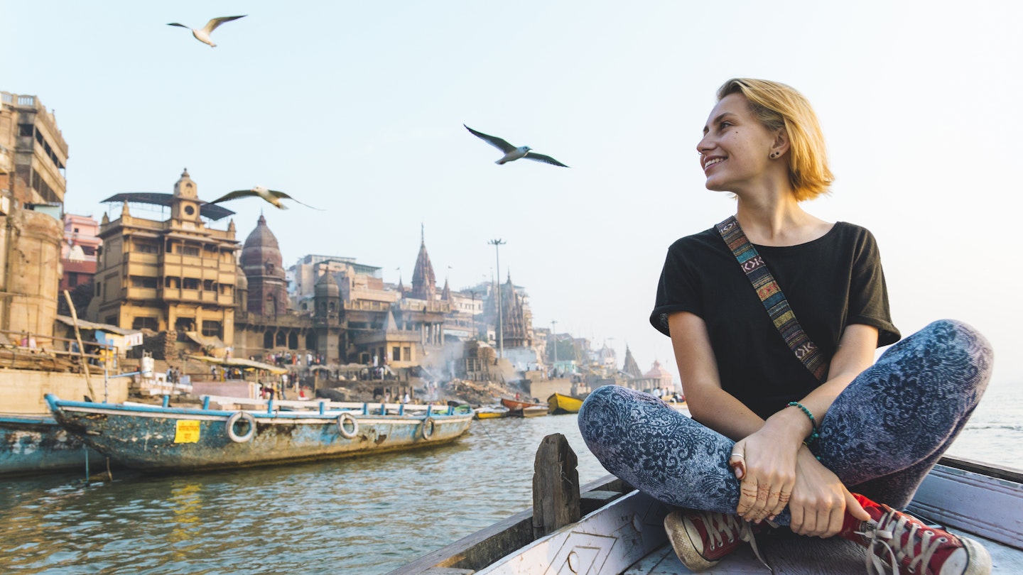 928851490
A woman tourist on a boat sailing along the River Ganges in India