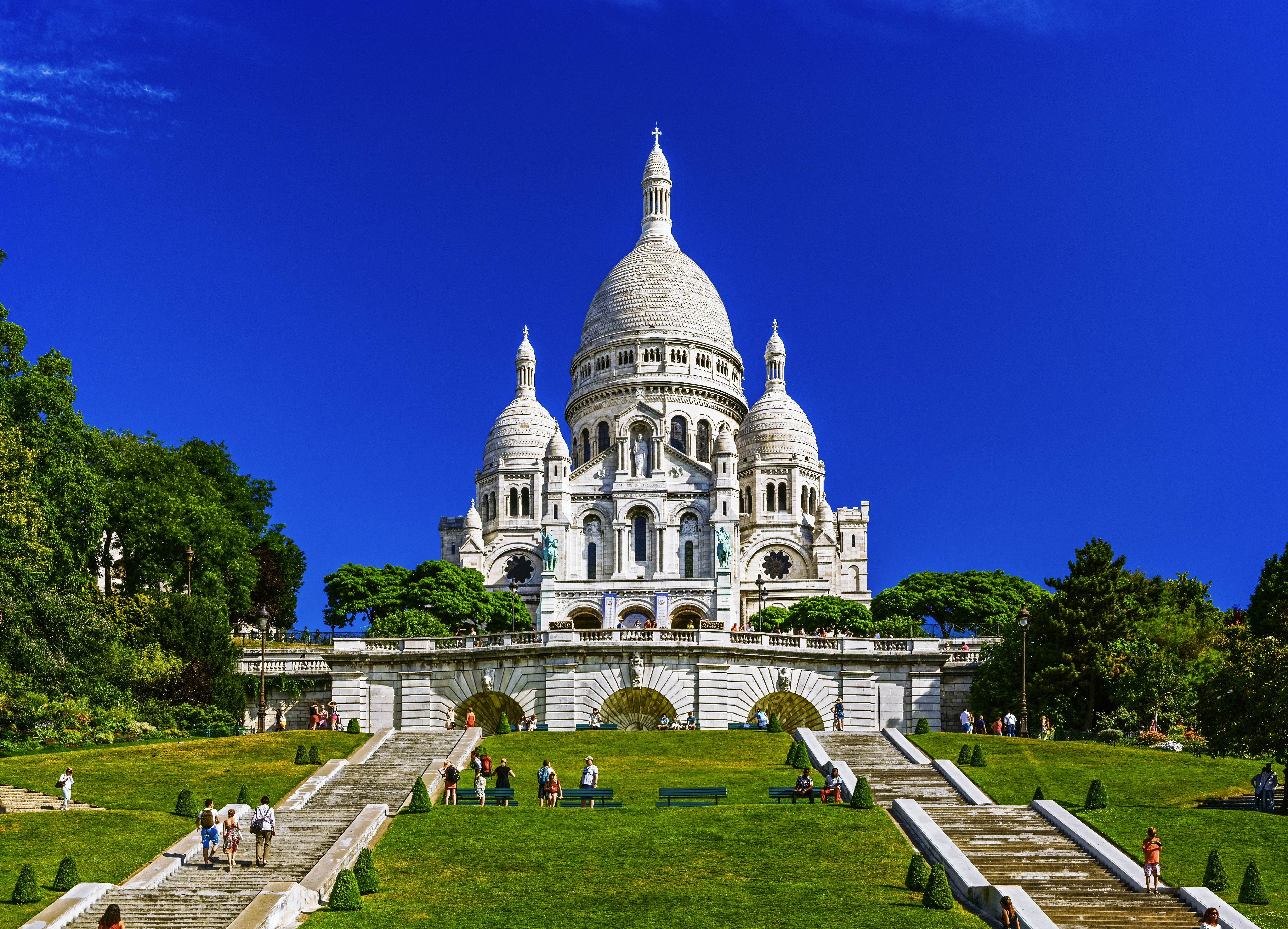 Built Structure City Architecture Travel Destinations Horizontal Outdoors Dome France Church Blue International Landmark French Culture Tree Day Paris - France Montmartre Religion Christianity Steps Color Image Grass Basilica City Life Incidental People Building Exterior Photography Distant Capital Cities Clear Sky Basilique Du Sacre Coeur - Montmartre WIllette Goutte D'Or Sunny
Sacre-Coeur Basilica on the mound Montmartre, Willette Public Garden, Montmartre District, Paris, France
